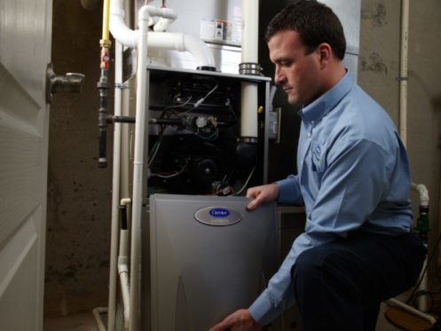 Furnace Technician Inspecting Furnace in Dickinson, TX